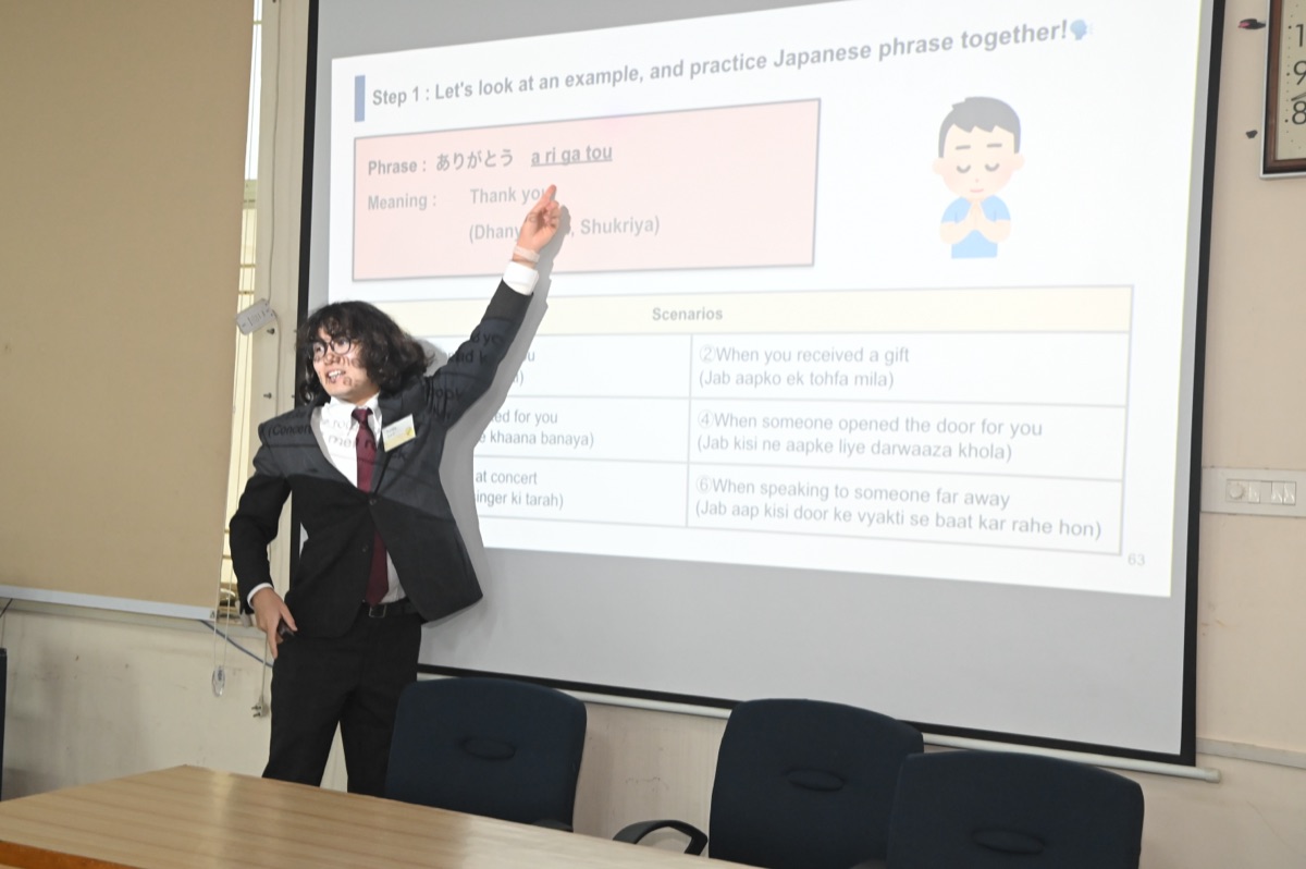Teacher presenting scenario-based learning materials with Japanese phrases